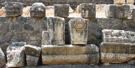 Decorative stone work including a lintel, a keystone from an arch and other fragments from a synagogue are seen here in Capernaum. 