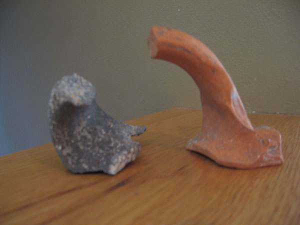 Handles from Beth Shan.  The dark handle is from a basalt cooking utensil and shows a Jewish presence in the city.  If a clay cooking pot became unclean it had to be smashed.  But a stone pot, such as the dark handled piece, could simply be purified in water to be reused if it became unclean.