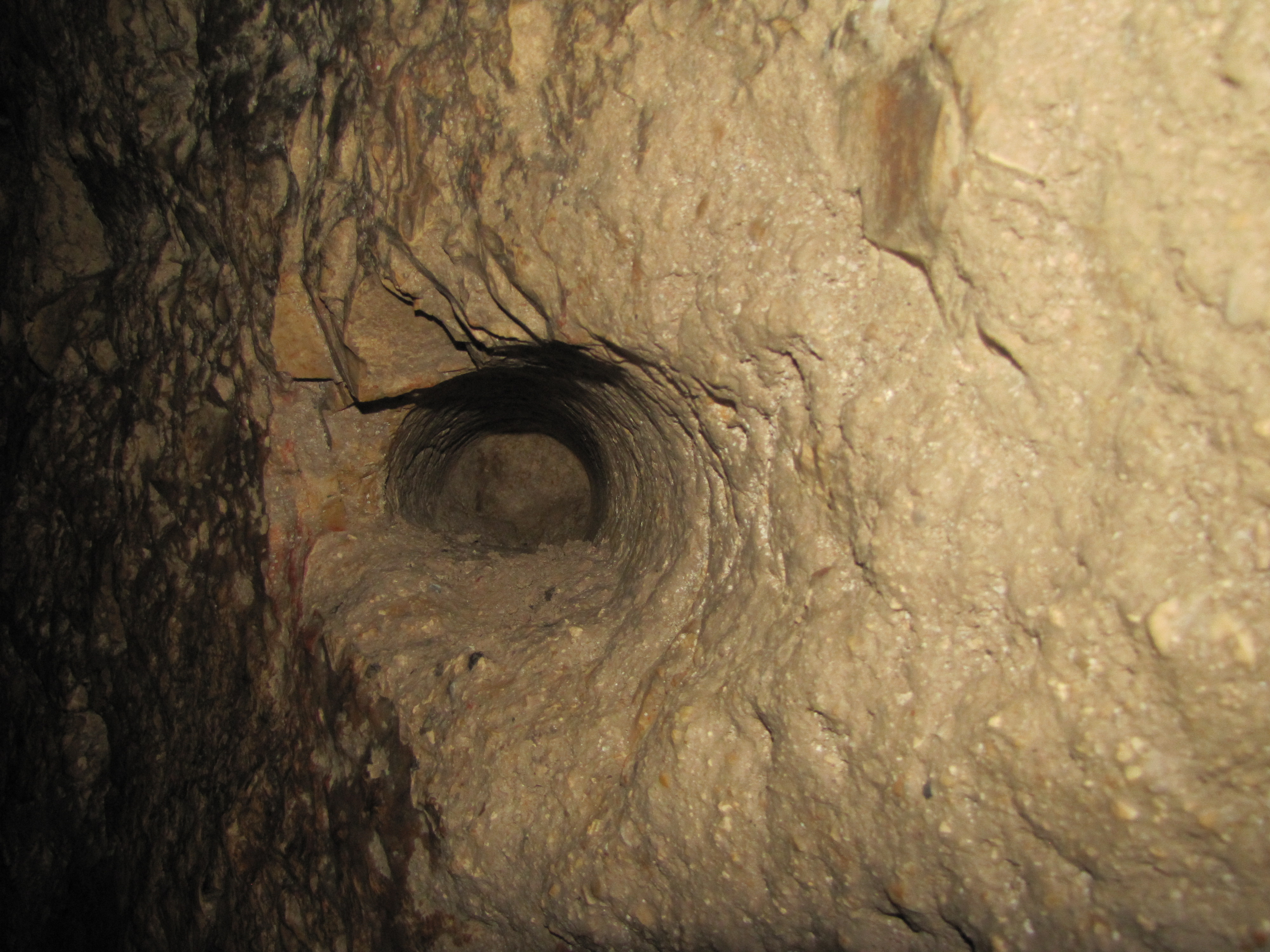 Chiseled hole in the bedrock to hold a torch for light for the workers in the tunnel