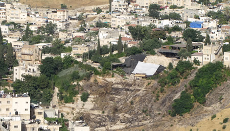 A view of the City of David from the east looking west on the Mount of Olives. The covered area is the Jebusite Wall (Stepped Stone Structure) which has the palace of David setting right above it. 