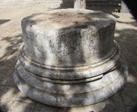 The base of a Roman column marked with the image of the letter delta (a triangle) to help identify proper placement of the column. 