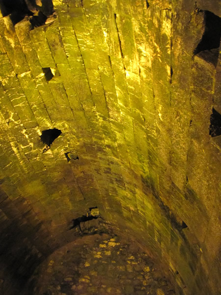 This arched ceiling was built over the open air pools on the northwest side of the first century Temple Mount. The pools were called Strouthion Pool. Hadrian covered these pools in 135 AD and set up a street market at ground level above. The square openings were for lowering buckets from the street to get water. These pools are underground now and still hold water.