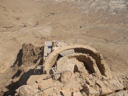 A view from the top down at Herod's three hanging palaces on the side of Masada.