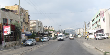 Driving through Kana in Israel. This is the New Testament village of Cana in Galilee where Jesus did his first miracle of turning water to wine in John 2:1-11. Today this is an Arab town with a population of about 18,000 called Kafr Kanna. 