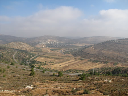 The road (mentioned in Judges 21:19) in the Hill country of Benjamin that goes from Lebonah, straight ahead in the photo, to Shiloh, to the right off the photo. 