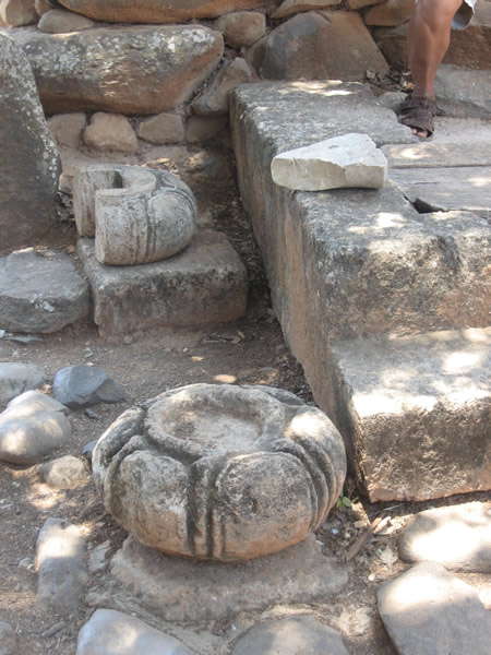 Circular stone socket for base of wooden pillar and canopy that covered elevated platform of king and governor on their seat or throne in the city gate of Dan