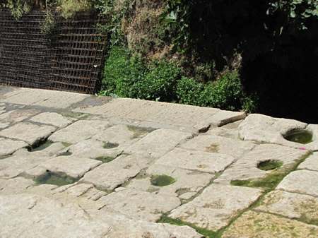 circular, cone-shaped pits used to support a water jar as it was being filled up at the Pool of Siloam