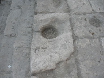 Holes were cut into the stone deck and the stone steps to hold the water jugs while they were being filled.